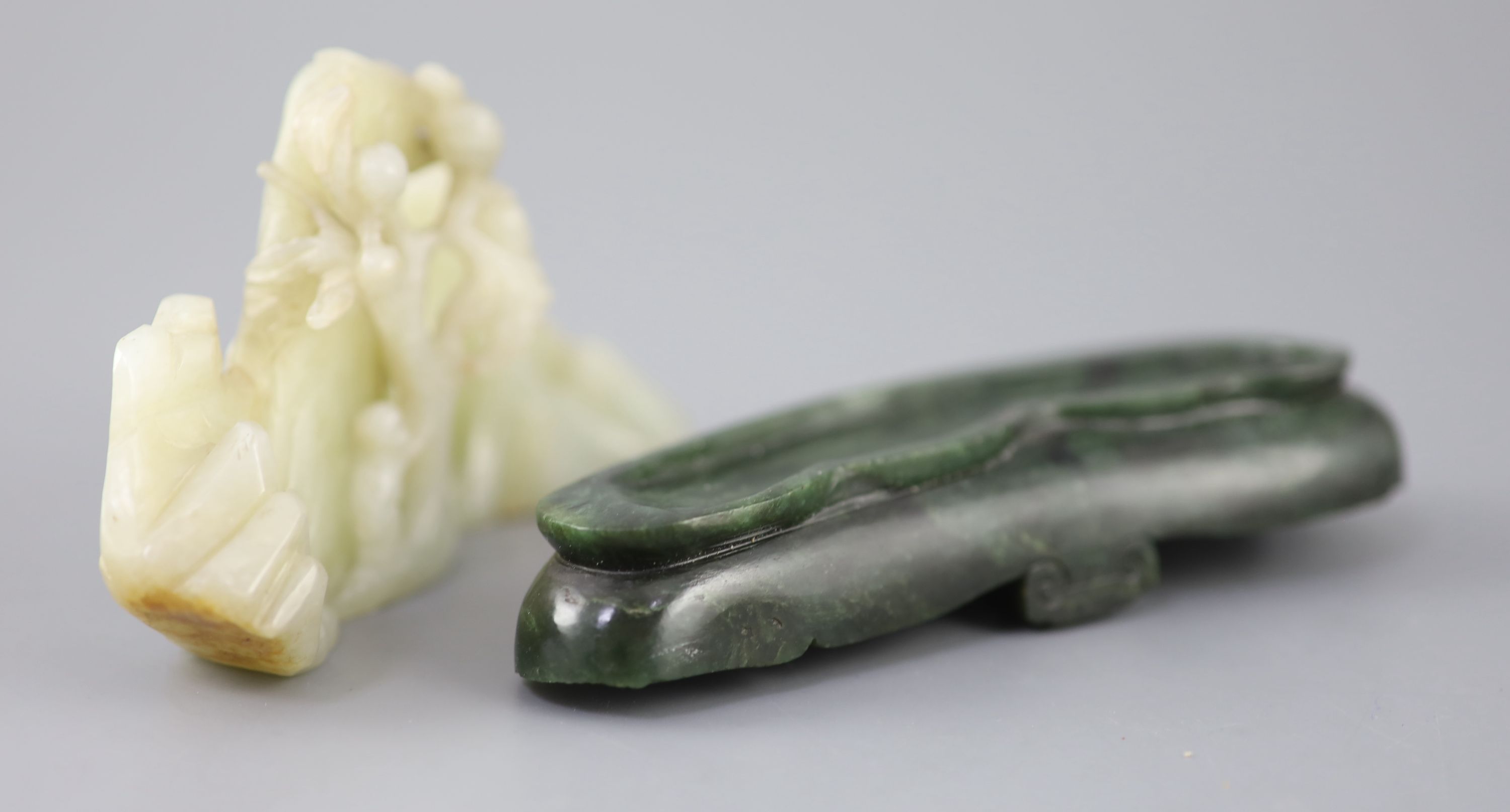 A Chinese pale celadon jade boulder carving, Qing dynasty, 13cm wide, the spinach green jade stand probably later
